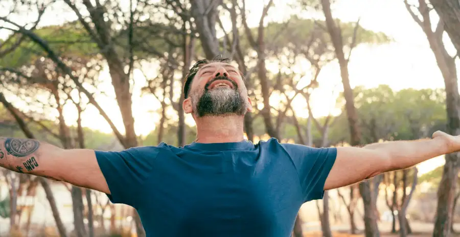 A man finding peace and renewal outdoors in recovery
